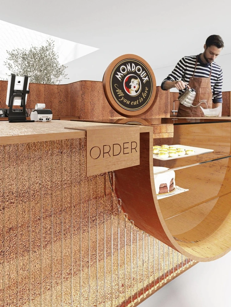 Barista za pultom kiosku Mondieu Specialty Coffee v Eurovei
